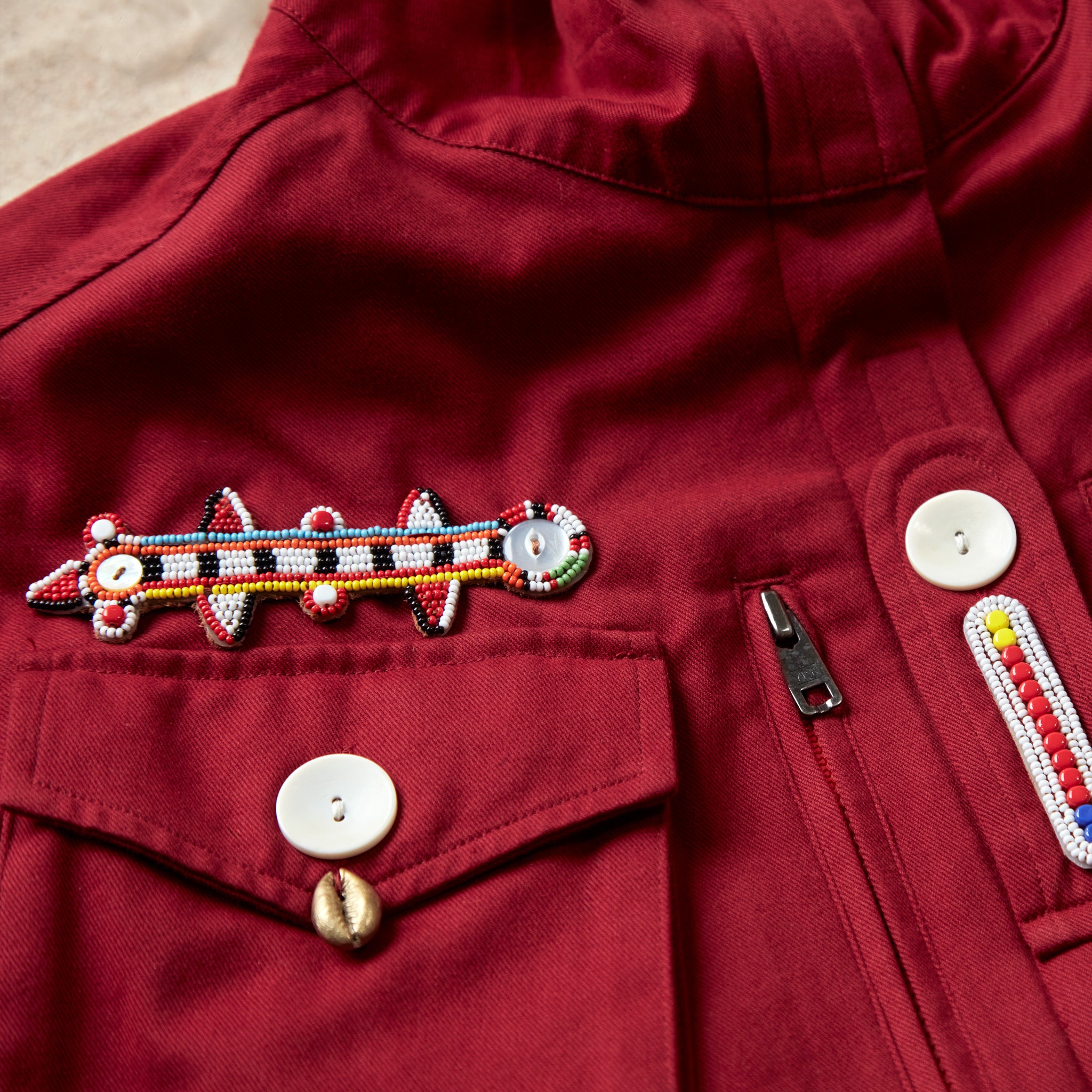 Another detail view of the colorful hand beaded patches on the red ranger safari jacket