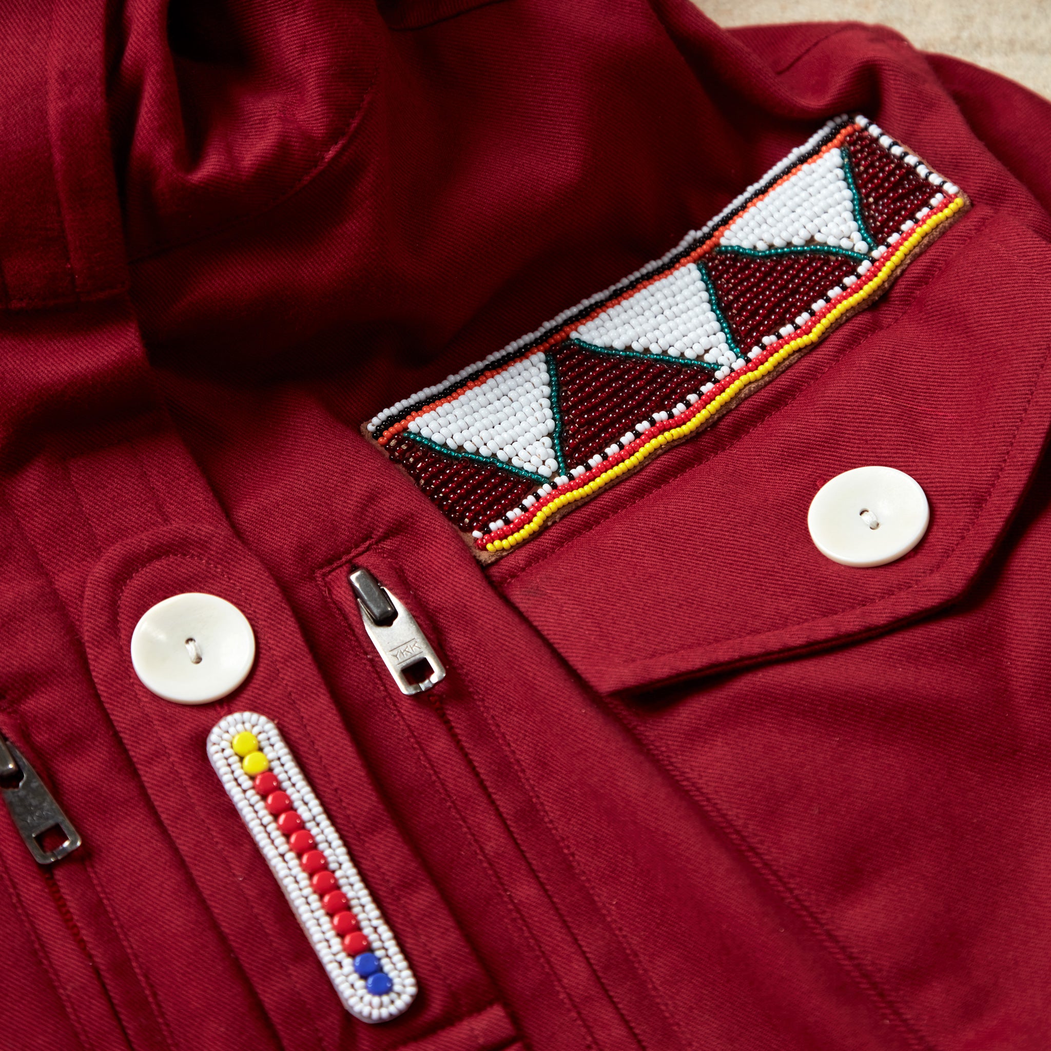 Close up of colorful hand beaded patches on the red ranger safari jacket
