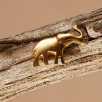 Brass elephant pin on a wooden branch