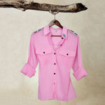 Pink Lightweight Ranger Shirt with White and Colorful Beaded Epaulettes on a hanger from a branch