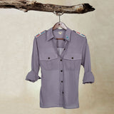 Grey Lightweight Ranger Shirt with White and Colorful Beaded Epaulettes on a hanger from a branch