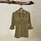 Light Khaki Green Lightweight Ranger Shirt with White and Colorful Beaded Epaulettes on a hanger from a branch