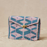 Beaded clutch bag with geometric pattern on a beige background