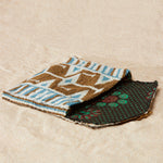 Open gold, white and blue beaded geometric bag with colorful kanga lining