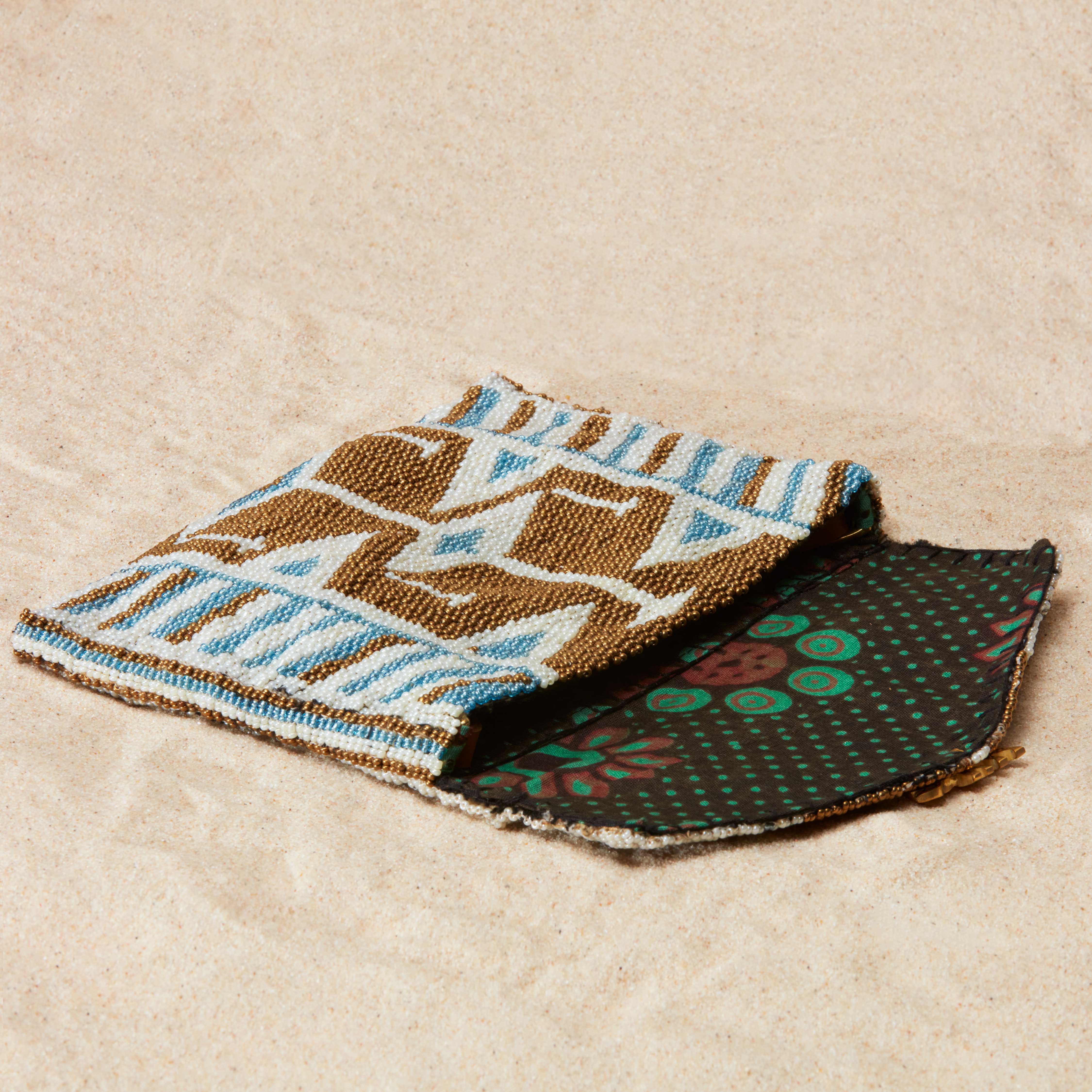 Open gold, white and blue beaded geometric bag with colorful kanga lining