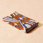 Colorful beaded clutch on a beige background