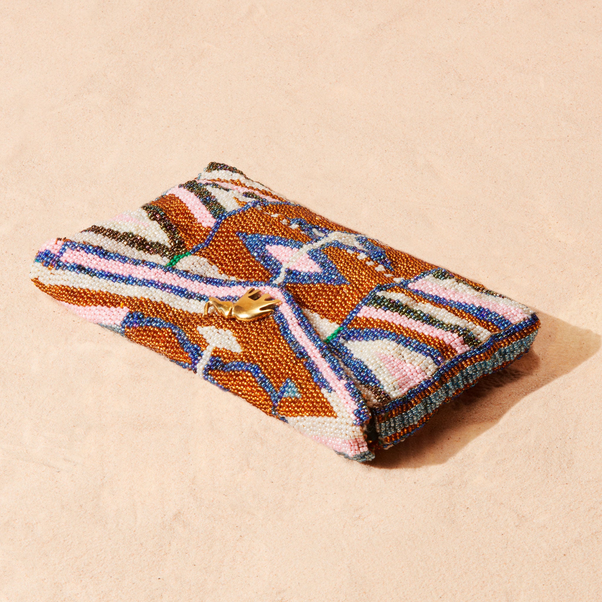 Colorful beaded clutch on a beige background