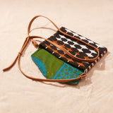 Handbag with geometric pattern showing green and blue kanga fabric lining