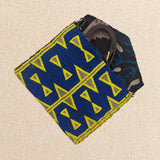 Interior view of small beaded clutch bag with a blue and yellow geometric pattern, featuring brown, blue kanga fabric lining and brown leather crossbody strap, set against a neutral beige background.