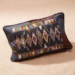 Decorative pillow with beaded geometric pattern on a beige background