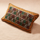 Rectangular pillow with beaded geometric pattern on a beige background