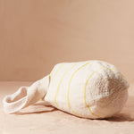 Bottom view of ivory woven bag with thin yellow stripes