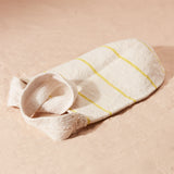 Flat view of ivory woven bag with thin yellow stripes