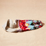 Flat View of colorful patterned woven bag on a sand surface