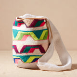 Colorful woven bag with geometric pattern on a beige background