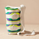 Woven bag with colorful pattern on a beige background