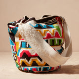 Colorful woven bag with a pattern on a beige background