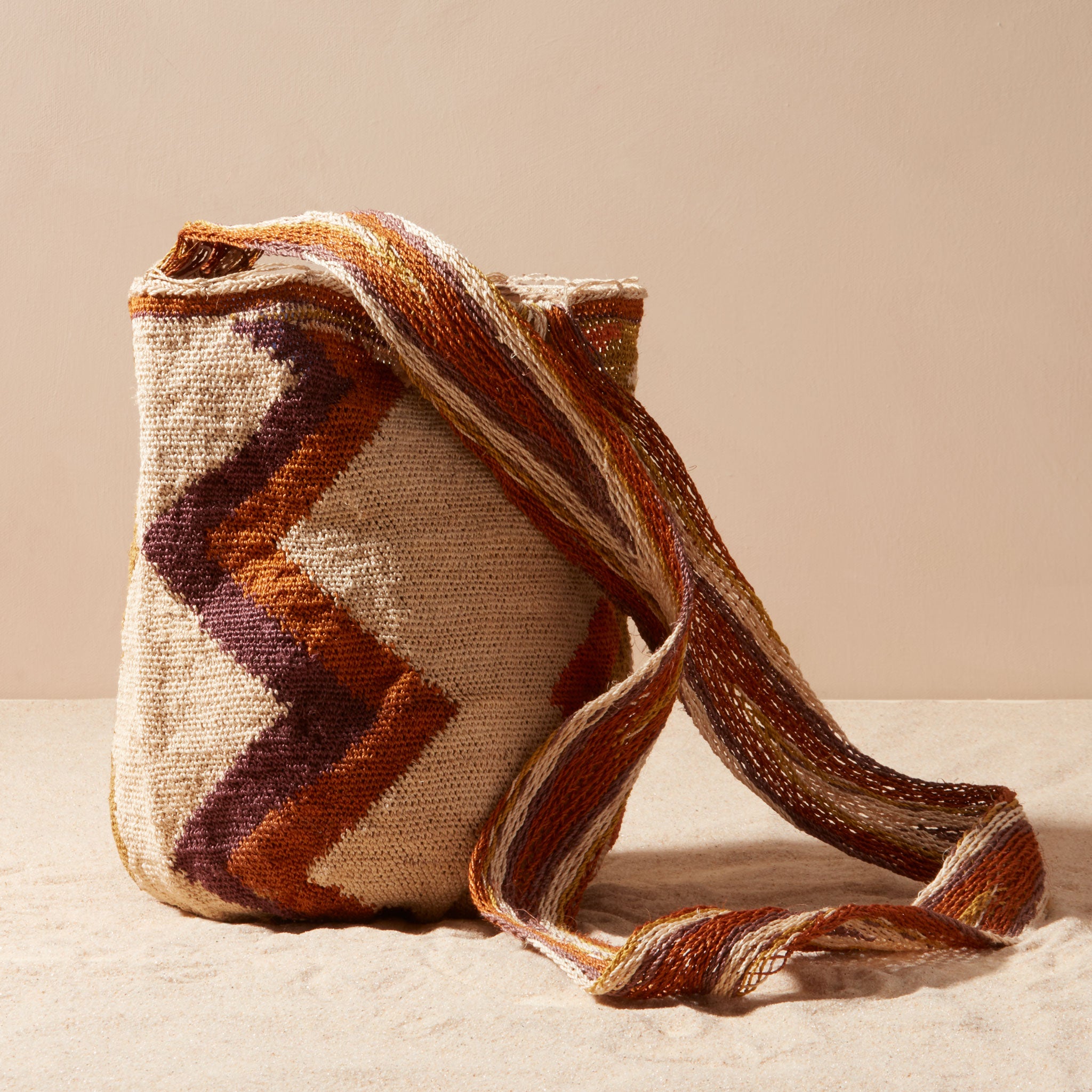 Woven bag with brown and beige pattern on a light background