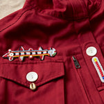 Another detail view of the colorful hand beaded patches on the red ranger safari jacket
