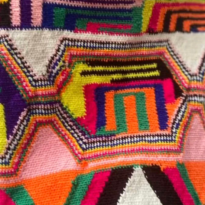 Colorful geometric patterned woven fabric with vibrant colors for a mochila bag